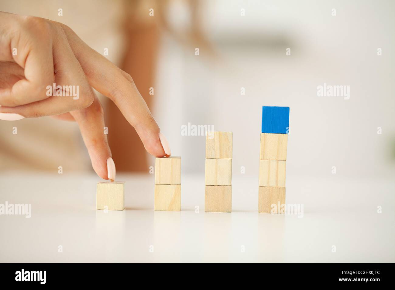 Hand arranging wood block stacking as step stair Stock Photo - Alamy