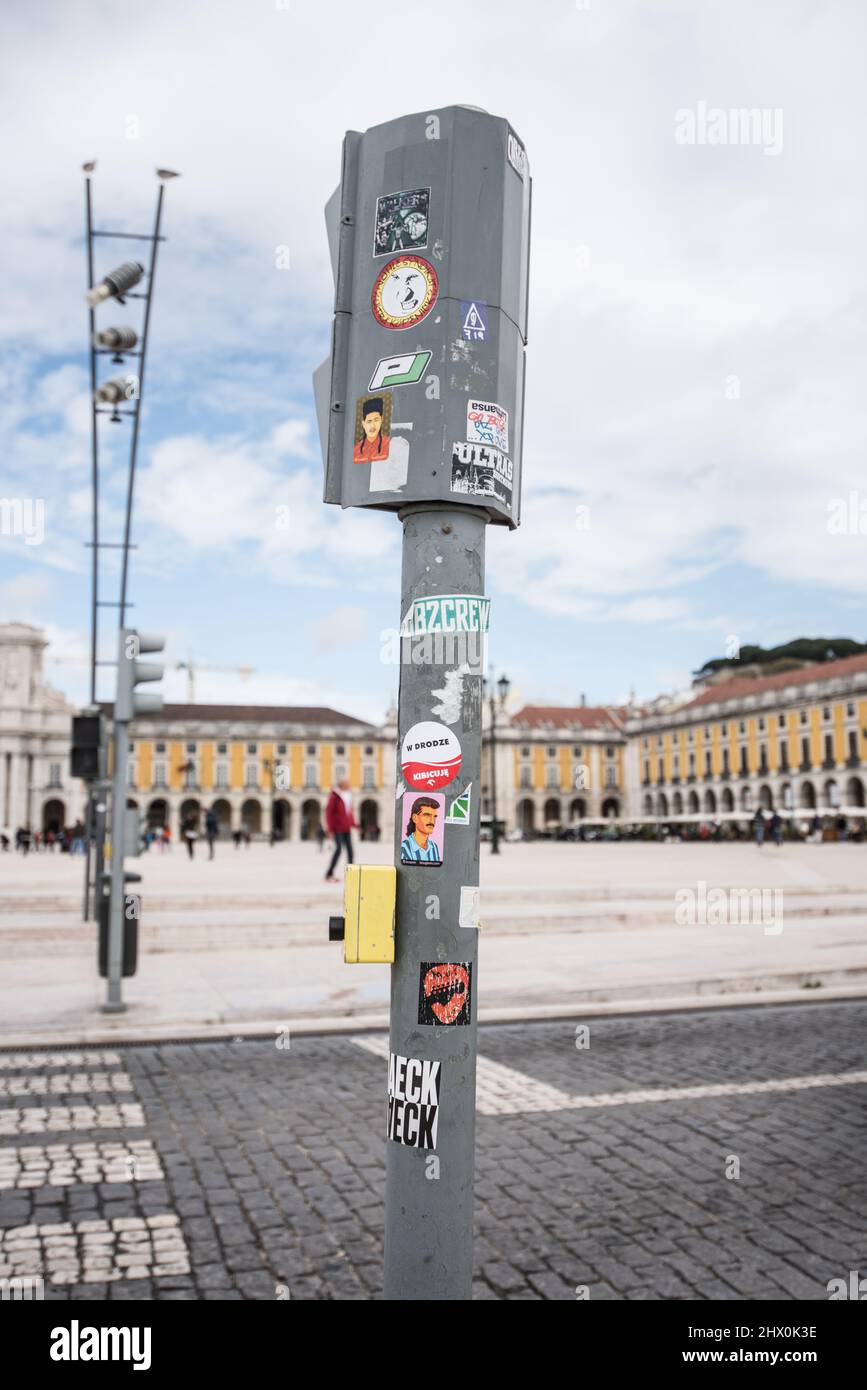 Traffic Light with a variety of different stickers pasted on it, in Lisbon, Portugal Stock Photo