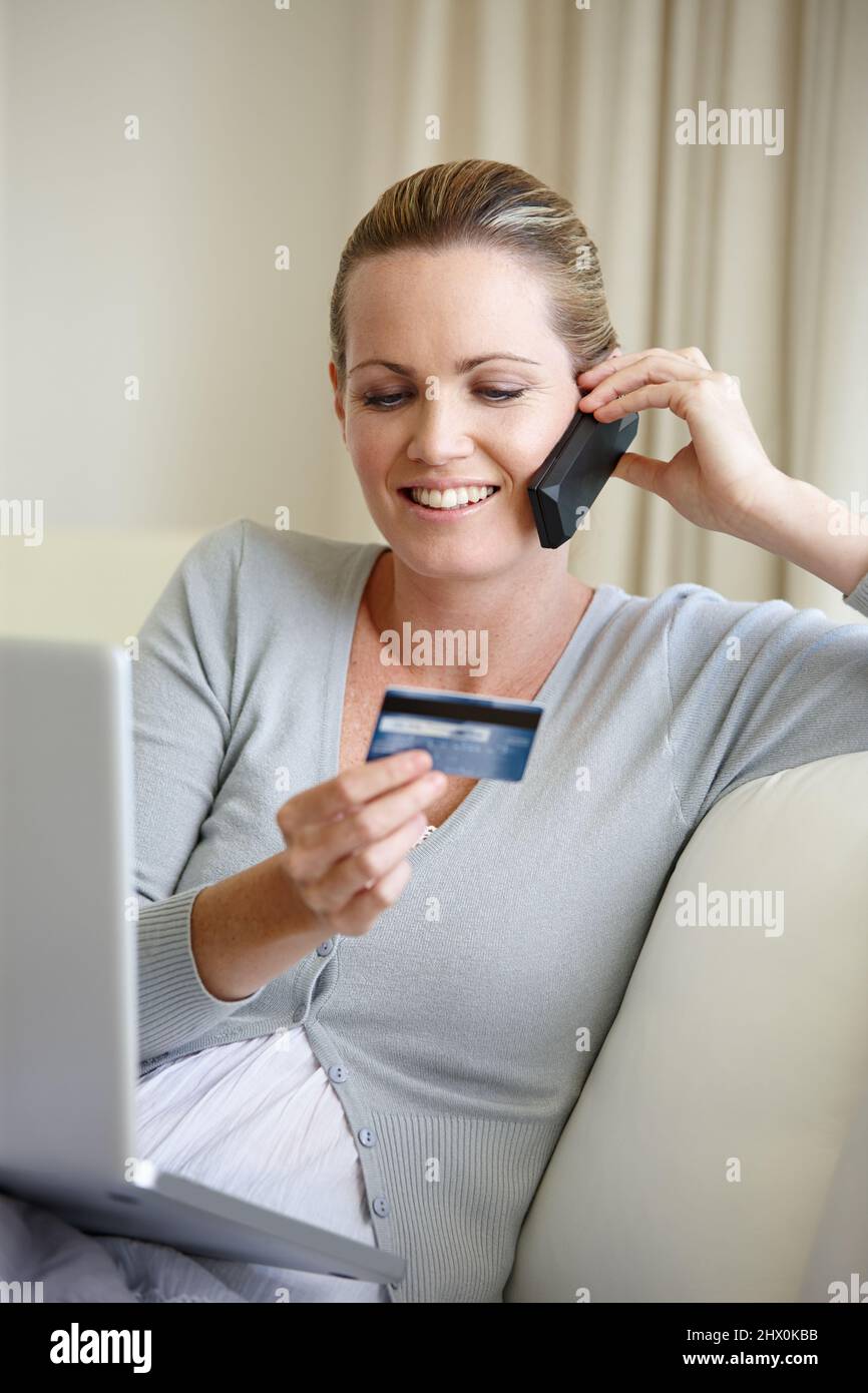 Multitaking is easy. A young woman talking on her cellphone while ...
