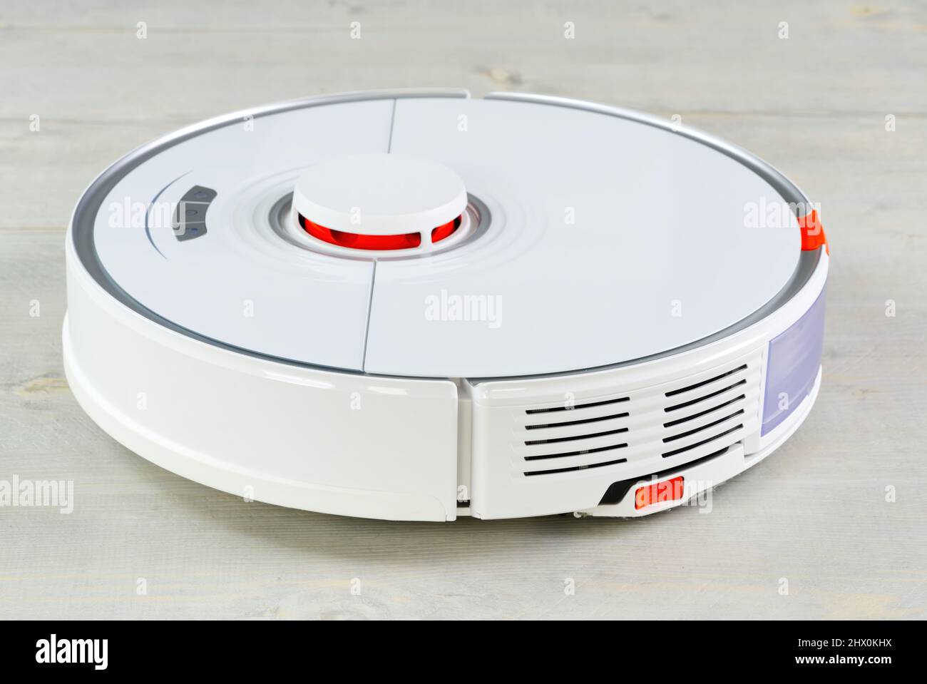 robot vacuum cleaner on the wooden floor cleaning the room. Smart