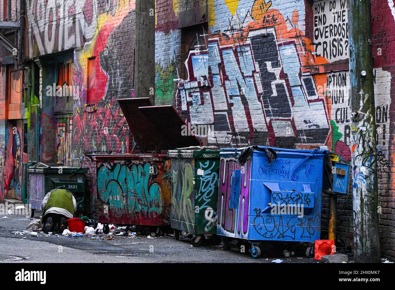 Homeless person scavenging in Downtown Eastside alley, Vancouver ...