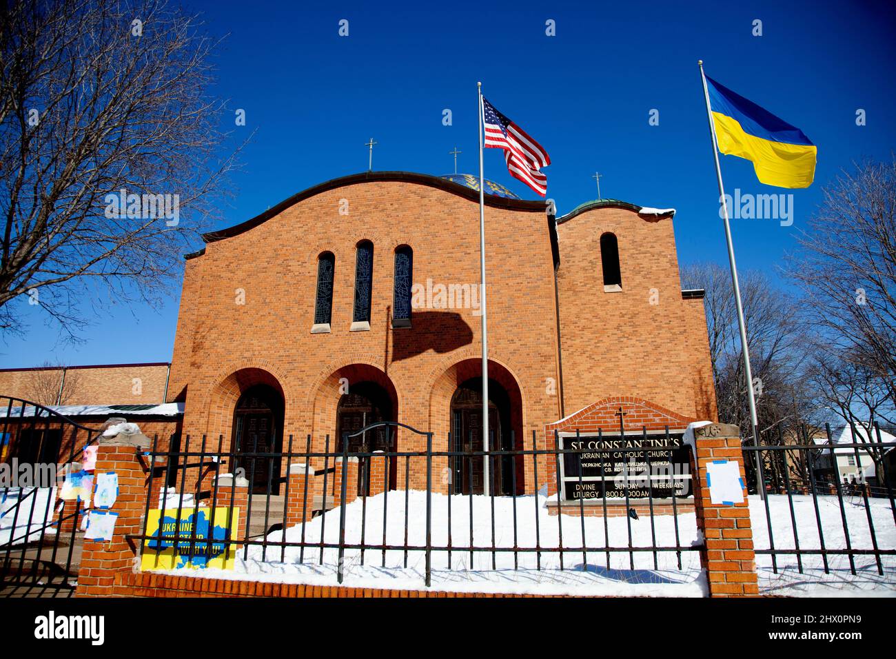 St. Constantine Ukrainian Catholic Church with both the Ukraine and American flag flying together showing support. Minneapolis Minnesota MN USA Stock Photo