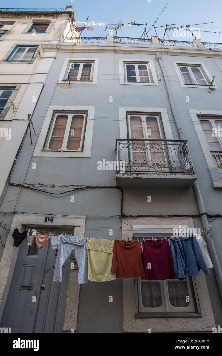 A typical Portuguese house, in Lisbon, with colourful clothing out to dry Stock Photo