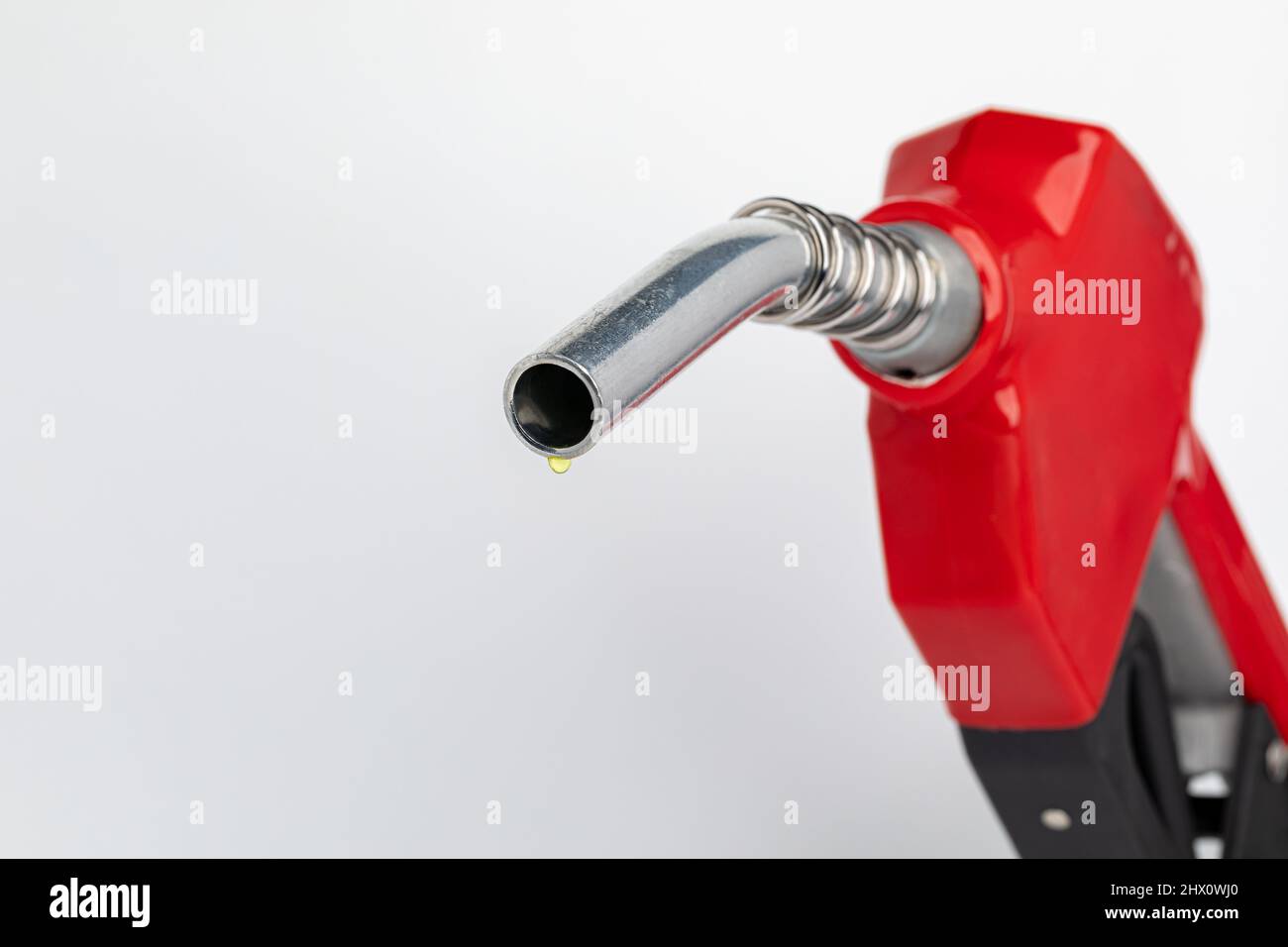 Gas dripping from fuel nozzle. Gasoline shortage, price and ethanol concept. Stock Photo
