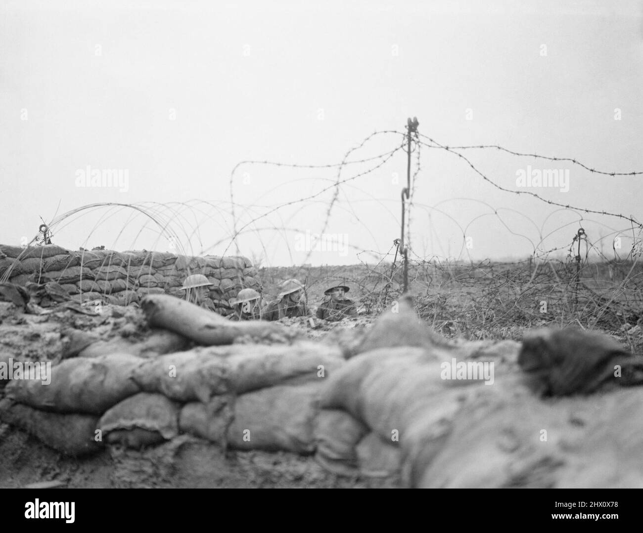 Men of the Lancashire Fusiliers, a barbed wire round the front line trench visible. Opposite Messines, near Ploegsteert Wood, January 1917. Stock Photo