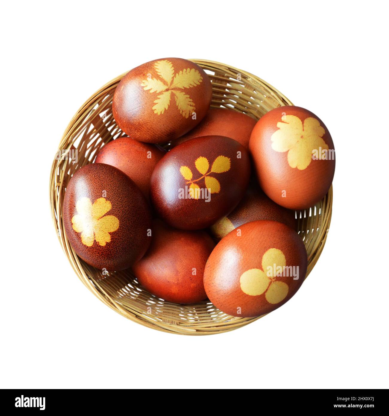 Top view of Easter basket. Naturally dyed eggs with onion skins in basket isolated on white background Stock Photo