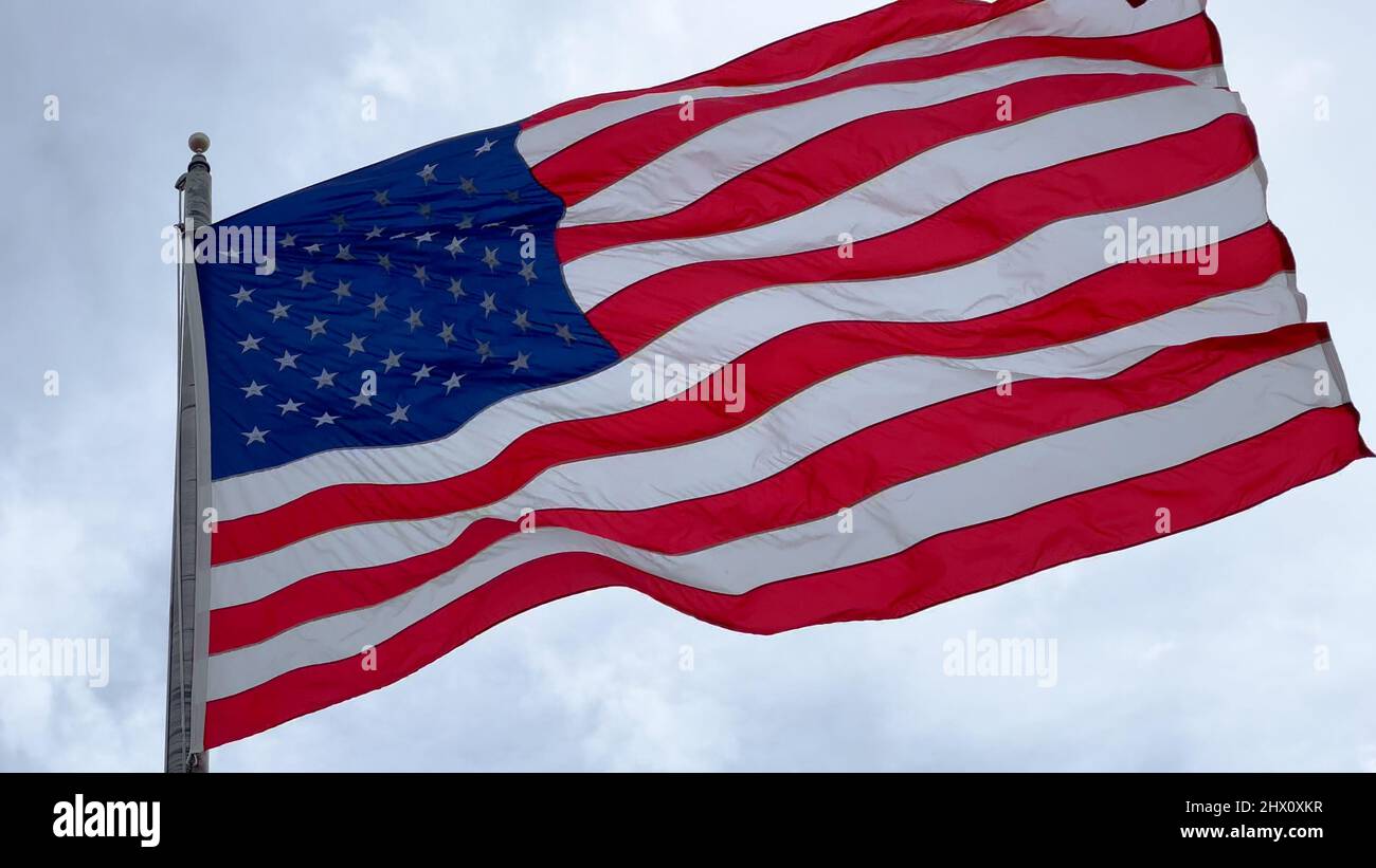 Huge Flag of the United States waving in the wind Stock Photo - Alamy