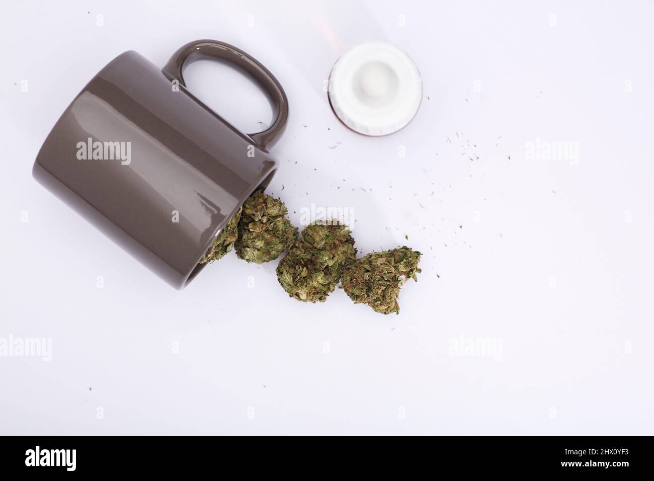 gray cup for infusion with marijuana, on a white background Stock Photo