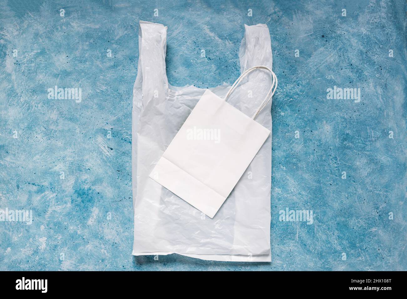 single use plastic bag next to paper one, plastic pollution and