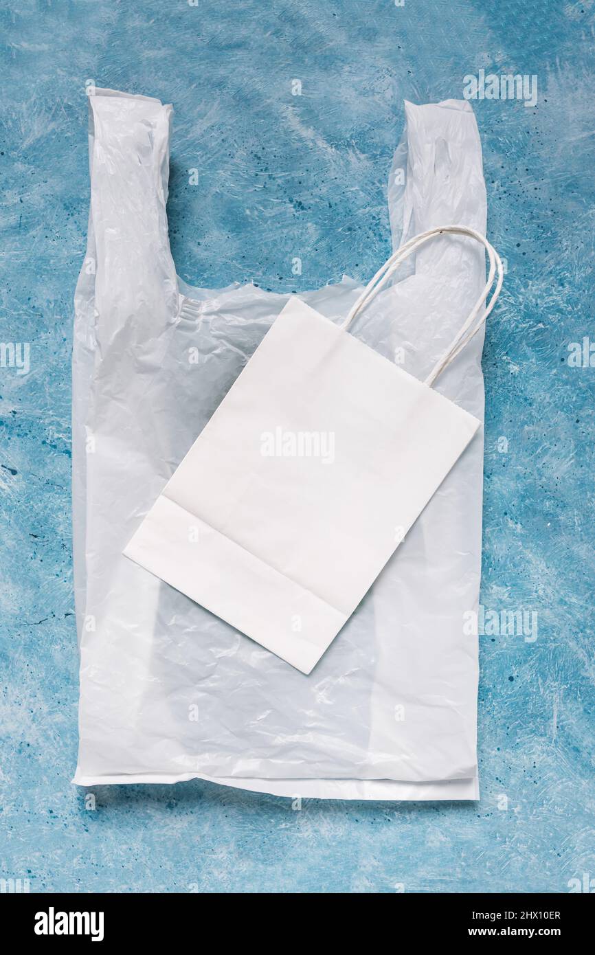 single use plastic bag next to paper one, plastic pollution and