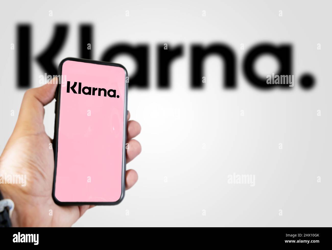 Rome, Italy, February 2022: Hand holding a device with the Klarna mobile app on the screen. Klarna is the largest private fin-tech start-up in Europe. Stock Photo