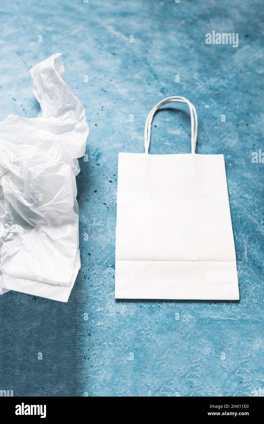 single use plastic bag next to paper one, plastic pollution and