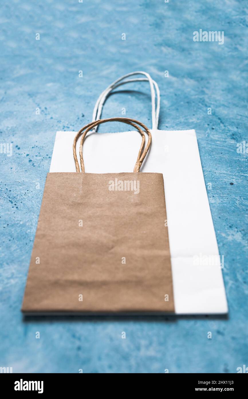paper shopping bags in different sizes and colours, concept of branding
