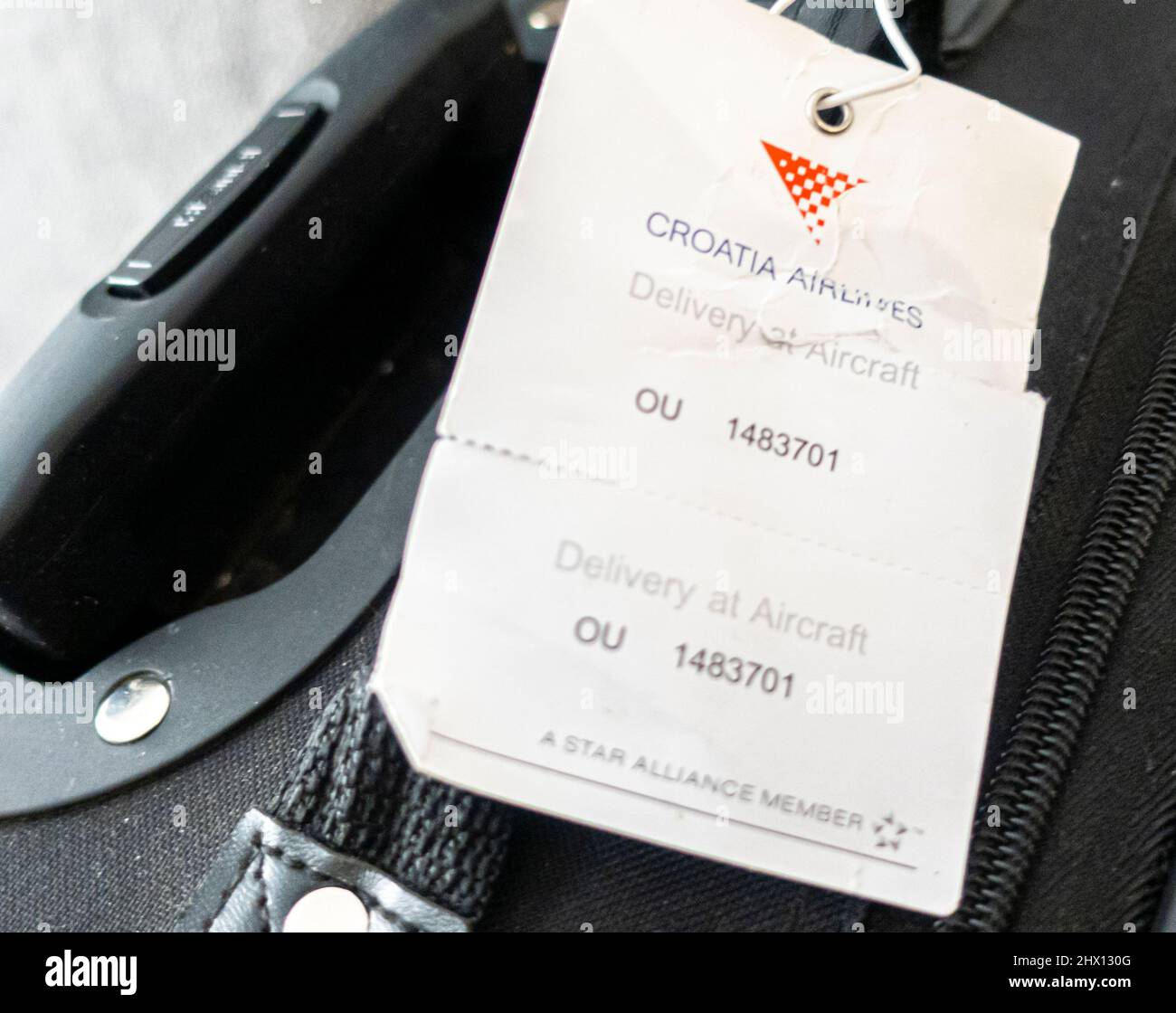 A suitcase with a Croatia airlinea carryon luggage baggage tag Stock