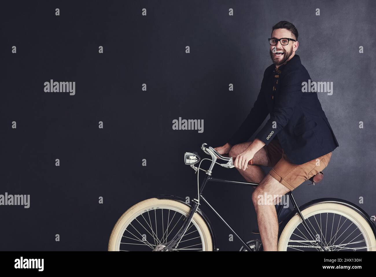 I ride my bike wherever I like. Portrait of a trendy young man riding a bicycle in studio Stock Photo Alamy