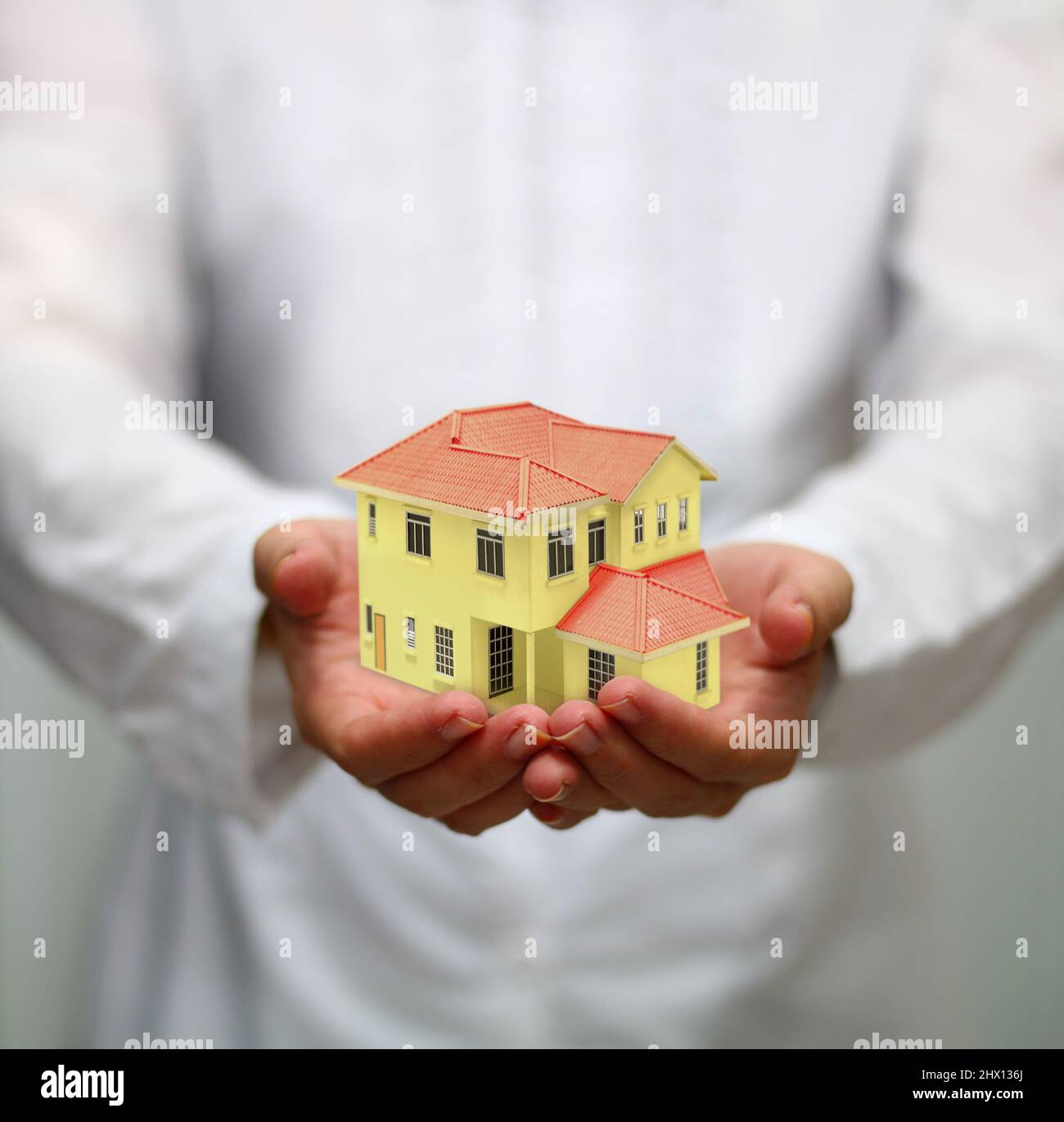 hand holding miniature house. housing loan concept Stock Photo Alamy