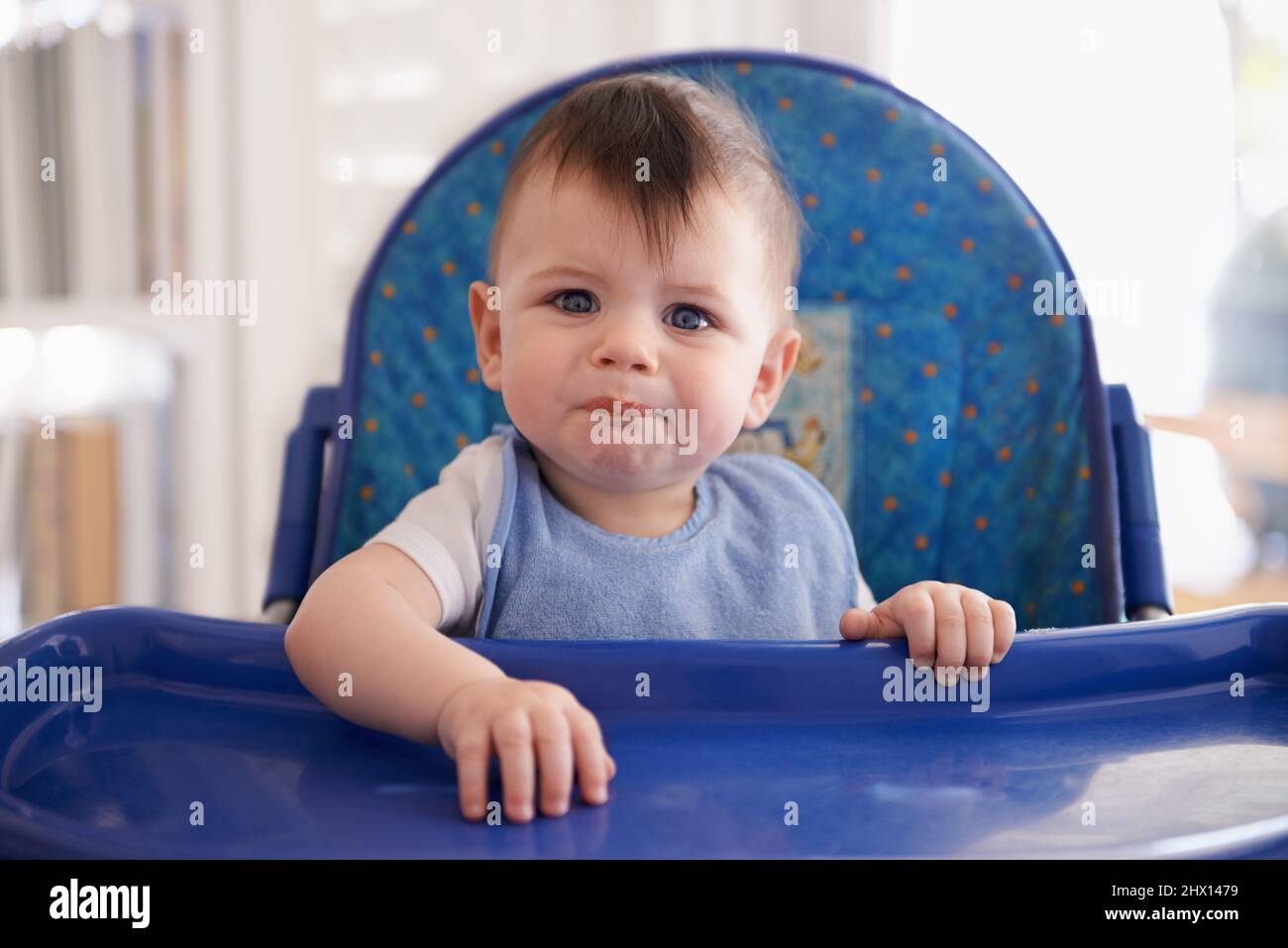 Mommy, can I have seconds. Portrait of a baby boy in his high chair Stock Photo Alamy