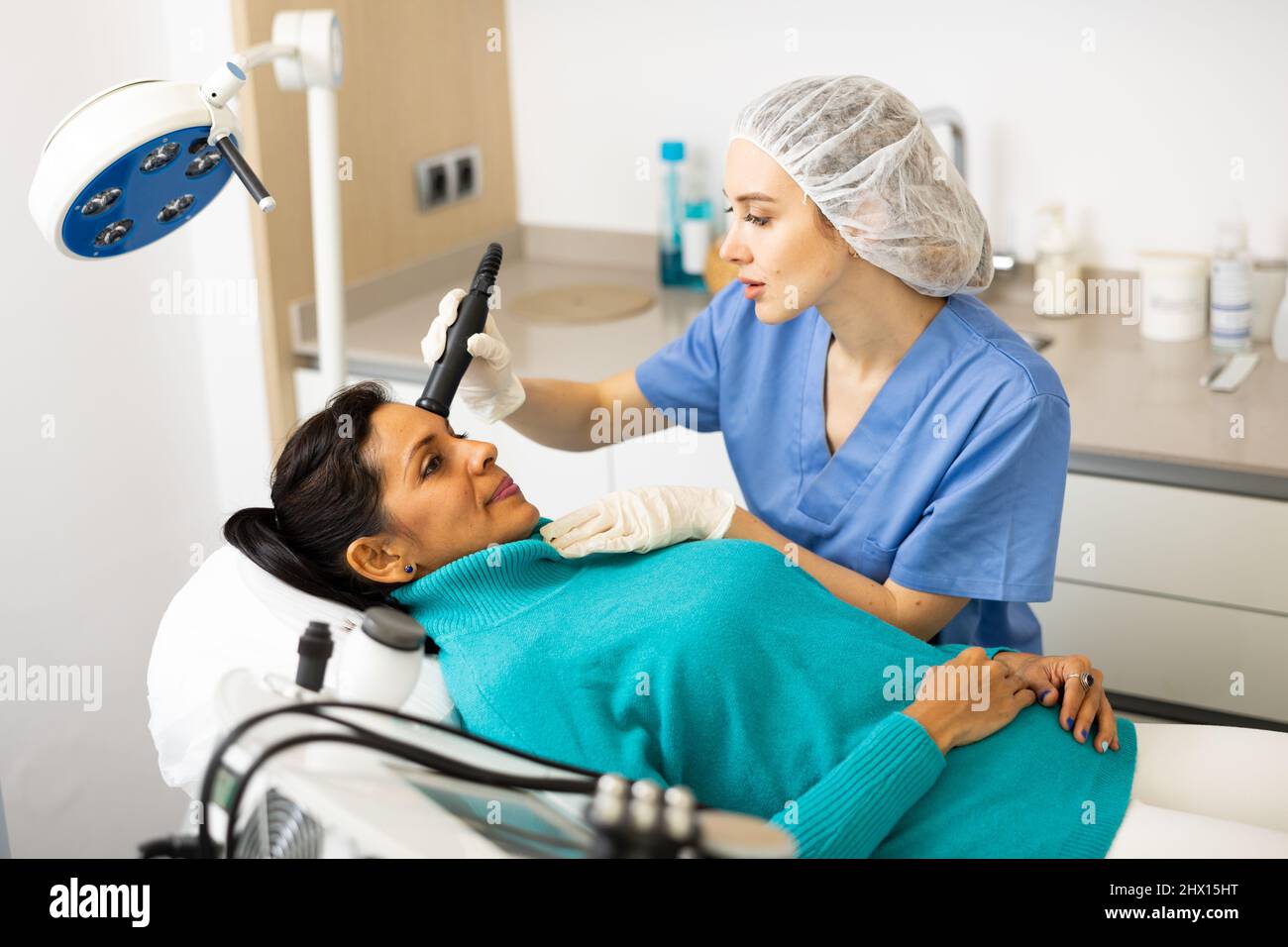 Woman receiving face ultrasound lifting procedure Stock Photo - Alamy