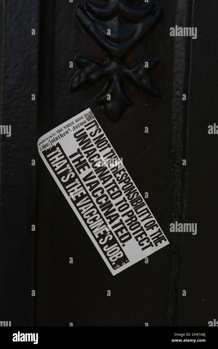 Christchurch, New Zealand, February 22, 2021: A sticker promoting a warning message that appeared on a building  during the anti-vaccine mandate campaign in Christchurch Stock Photo