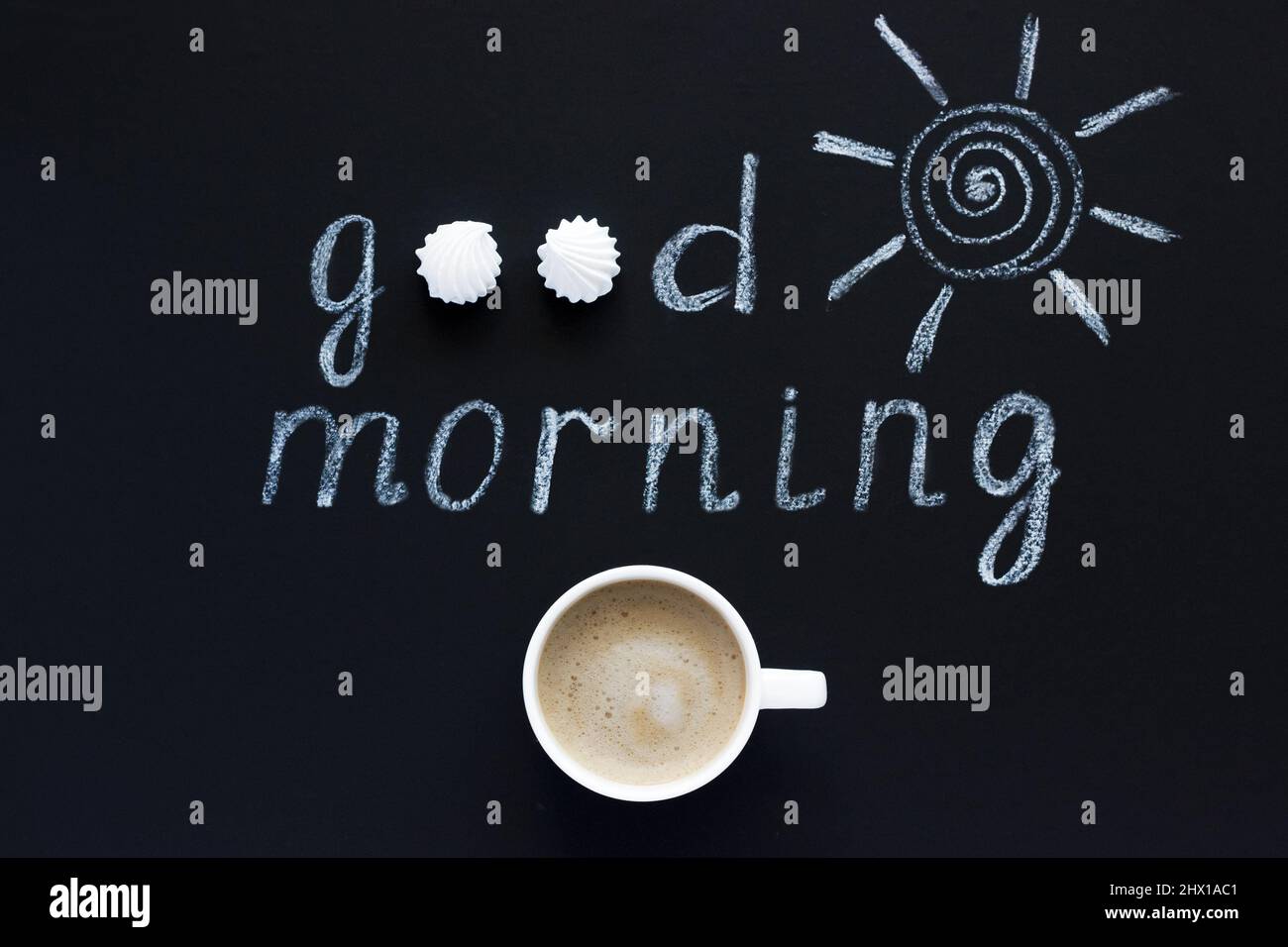 Text Good morning, sun chalk on black background, Cup of coffee, meringue. Flat Lay, Top View. Concept Stock Photo
