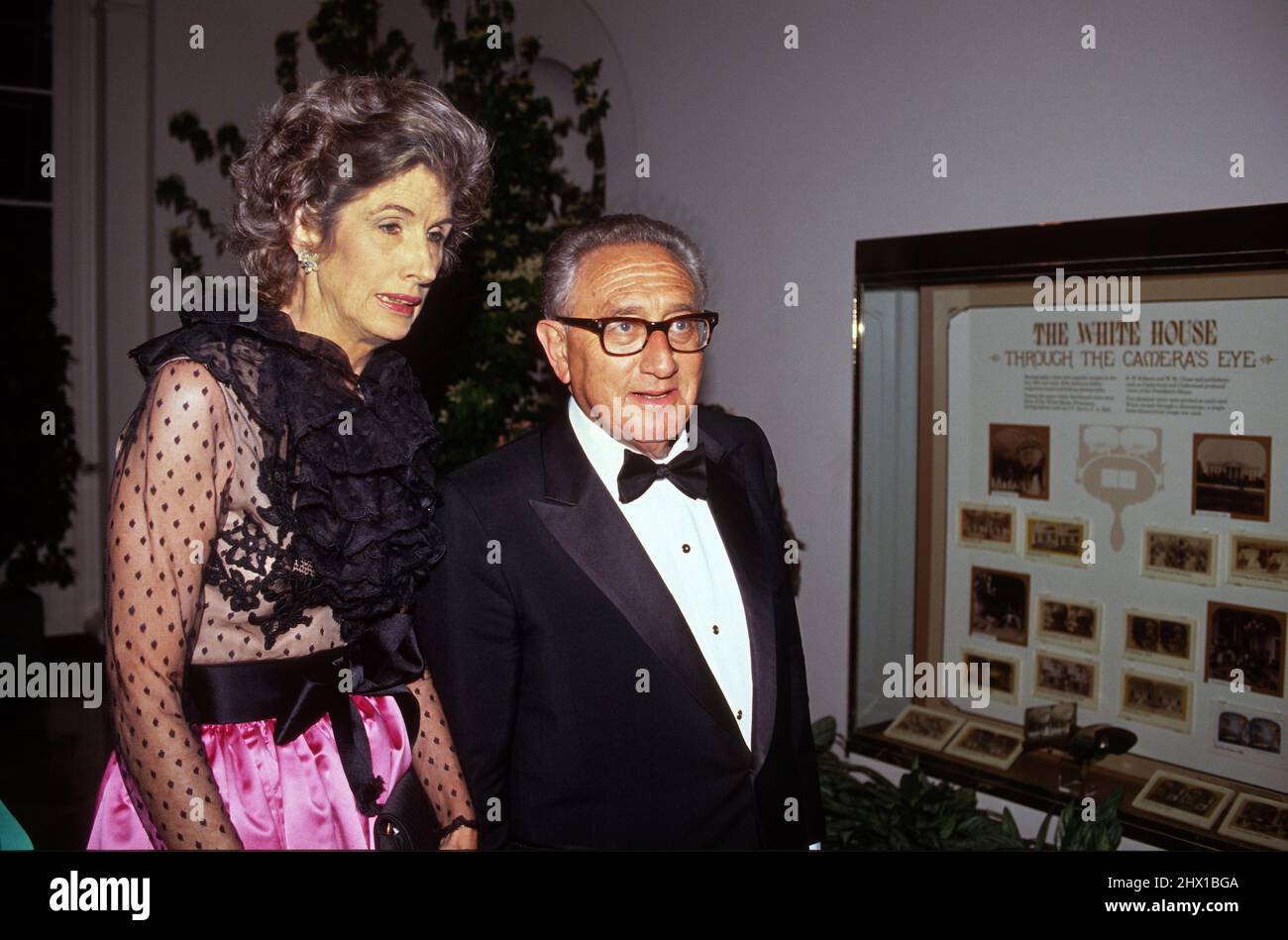 Former US Secretary of State Henry A Kissinger and his wife, Nancy, arrive at the White House in Washington, DC for the State Dinner honoring Queen Elizabeth II on May 14, 1991.Credit: Ron Sachs / CNP /MediaPunch Stock Photo
