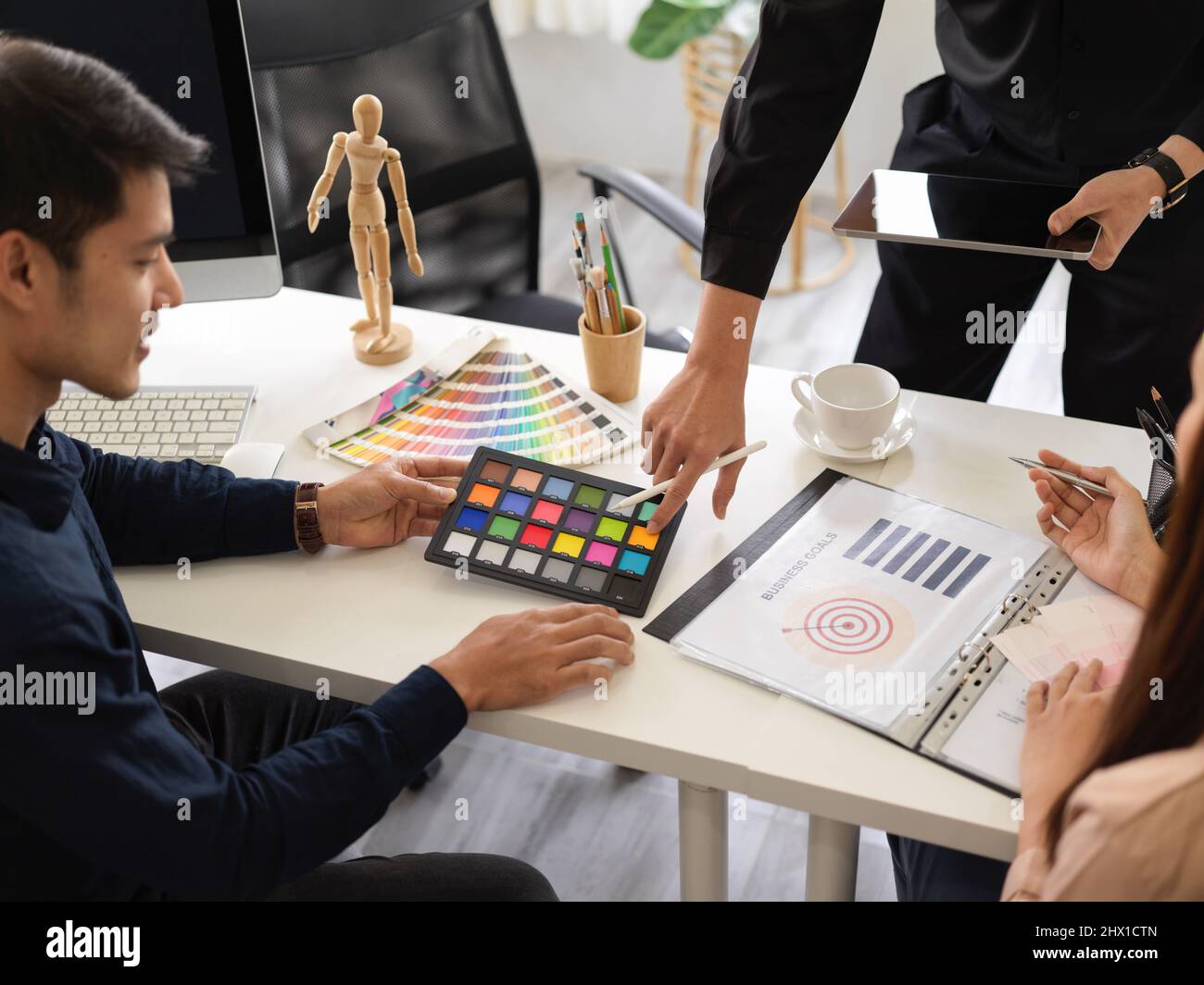 Close-up, Graphic designers working together as a teamwork, looking at ...