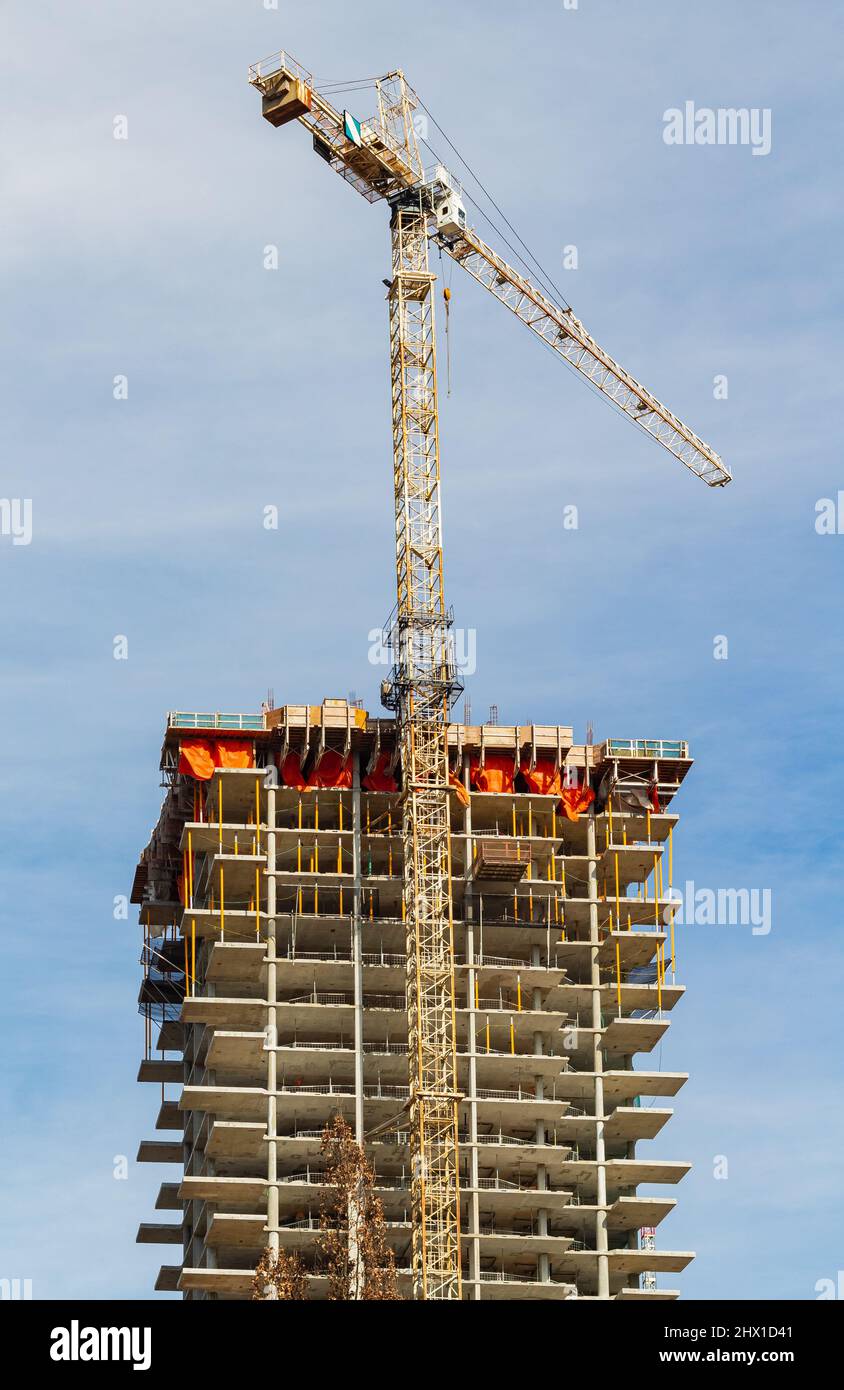 Building and cranes under construction against blue sky. Nobody, street photo, copy space for text Stock Photo