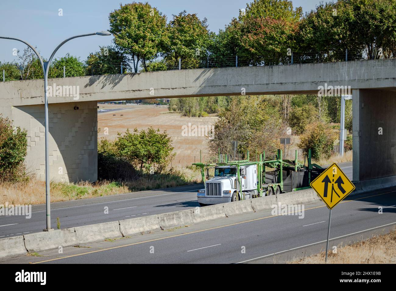 White industrial big rig classic semi truck tractor with truck driver ...