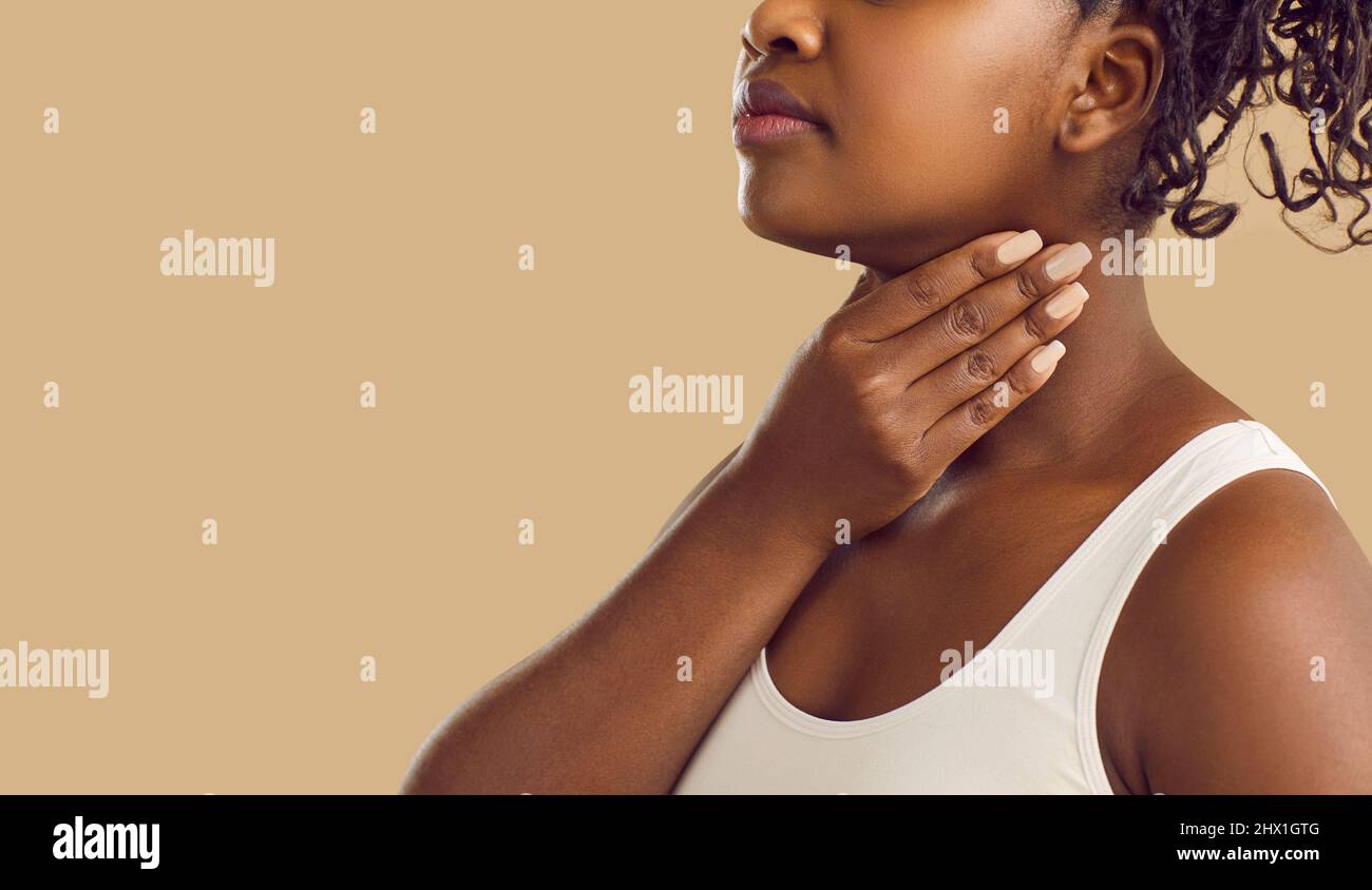 Copy space banner with black woman who has inflamed tonsil glands or sore lymph nodes Stock Photo