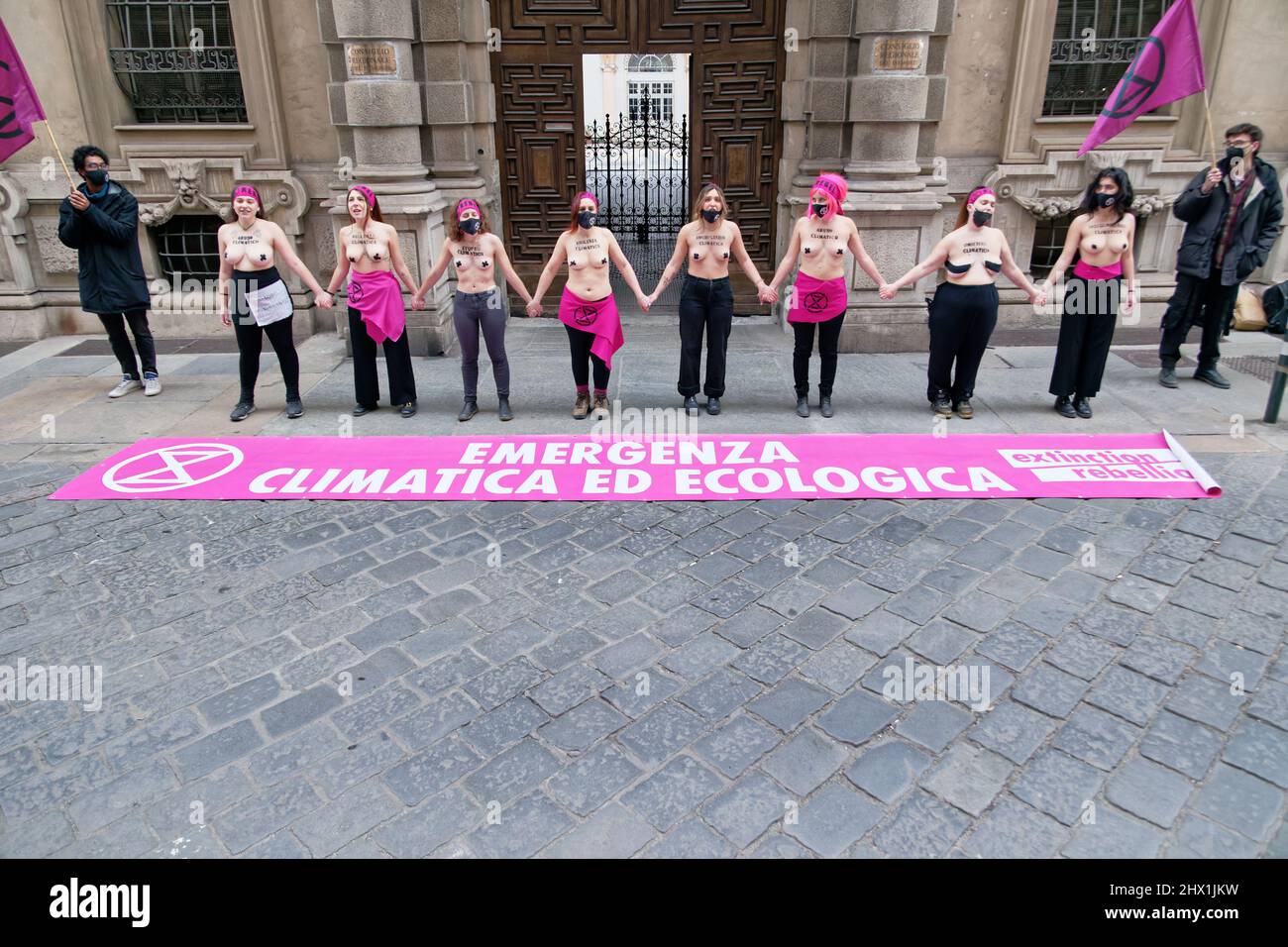 Turin, Italy. 8th Mar, 2022. Naked activists of Extinction Rebellion movement protest on International Women's Day against the climate crisis. According to the largest study on the subject, published by the International Union for Conservation of Nature (IUCN), the climate emergency and environmental crisis are responsible for an increase in violence against women while gender exploitation is hampering our ability to counter the climate crisis. Credit: MLBARIONA/Alamy Live News Stock Photo