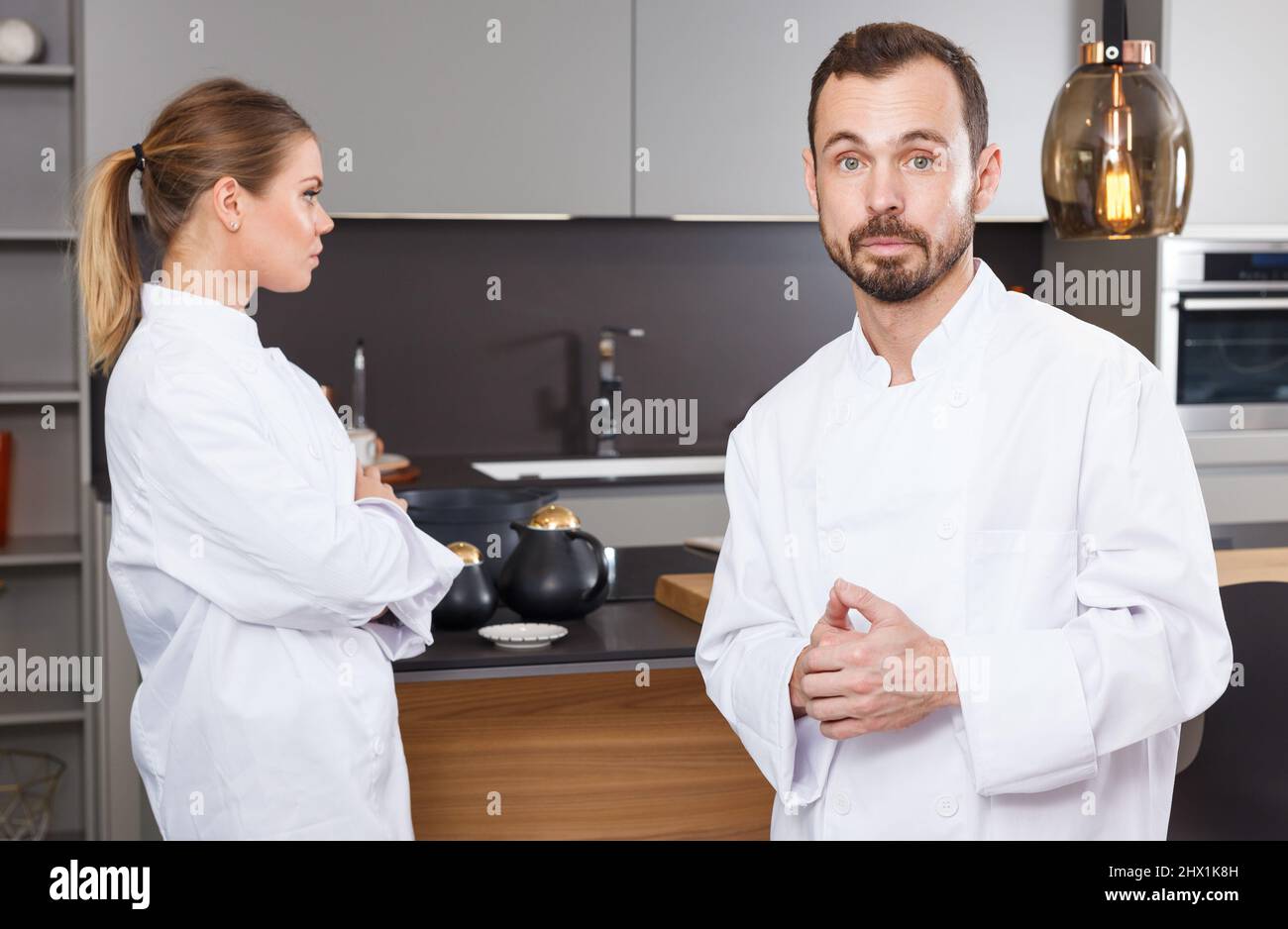 Two Cooks Create Mess Two cooks having disagreements Stock Photo - Alamy