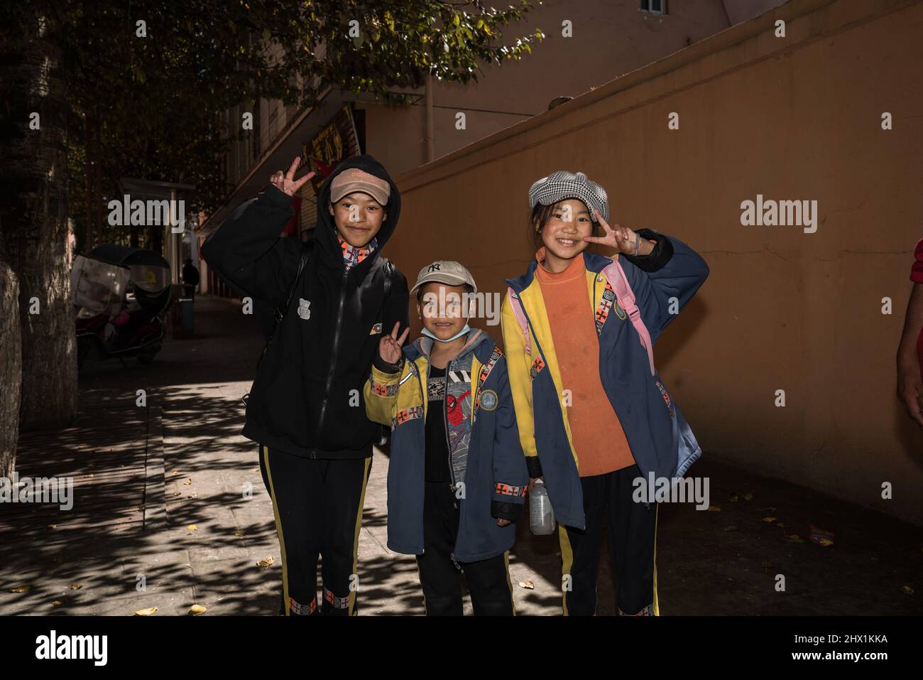 Litang, Garze, China: Portrait of young tibetan students on the street of Litang. Stock Photo
