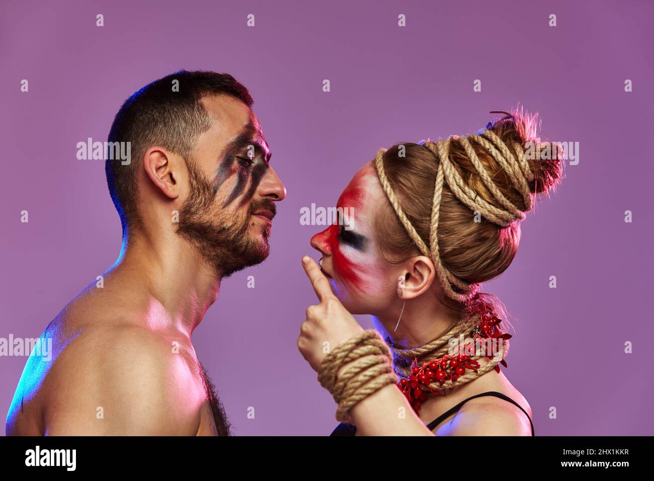 Beautiful young acrobats or gymnasts with colorful face painting on ...