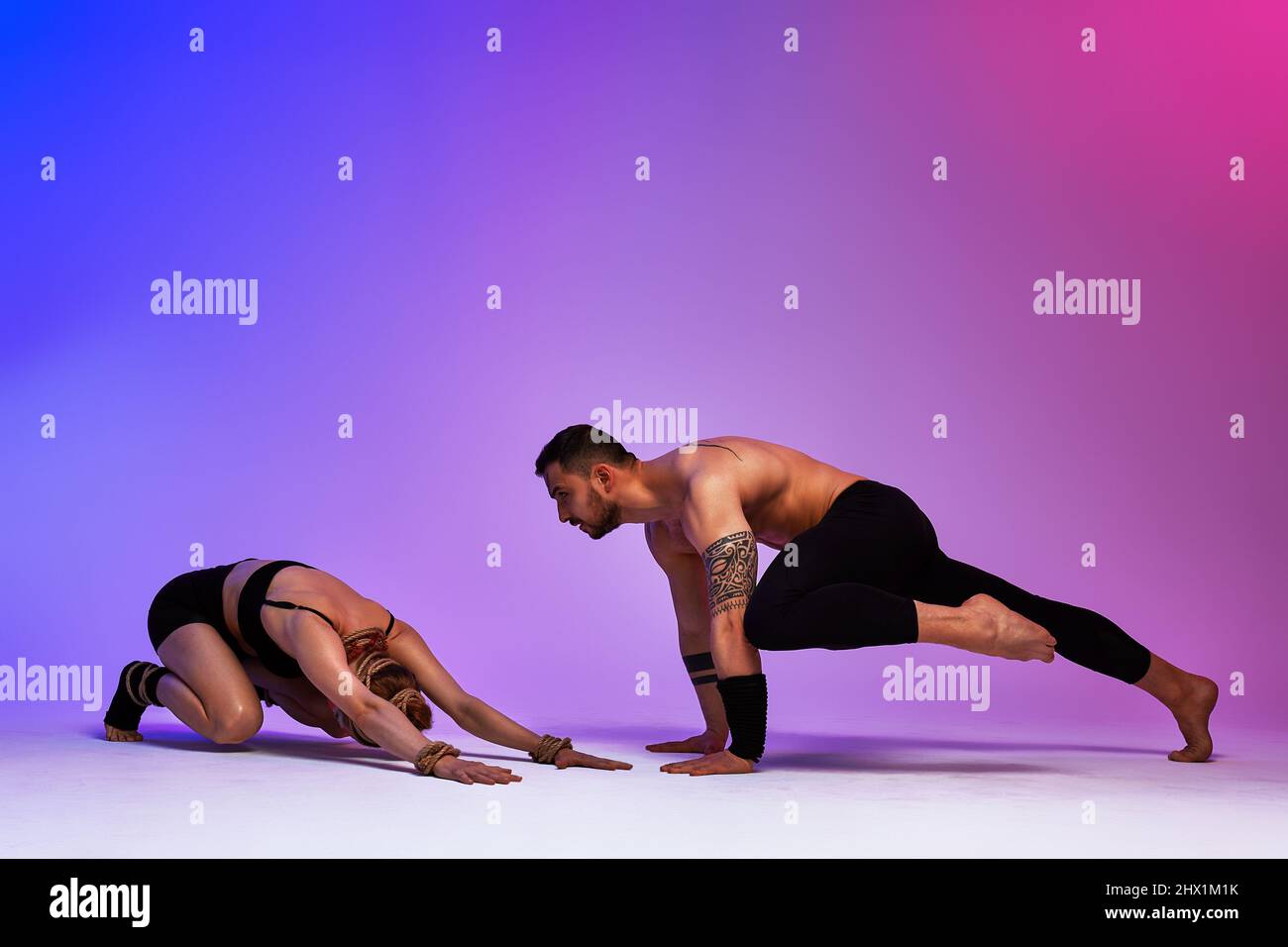 Beautiful young acrobats or gymnasts with colorful face painting on ...