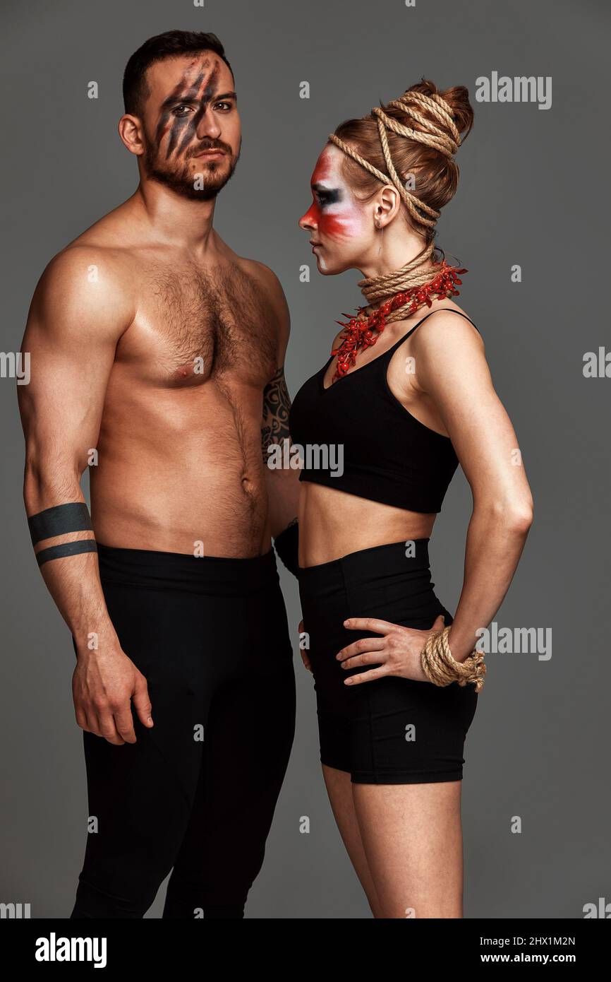 Beautiful young acrobats or gymnasts with colorful face painting on ...