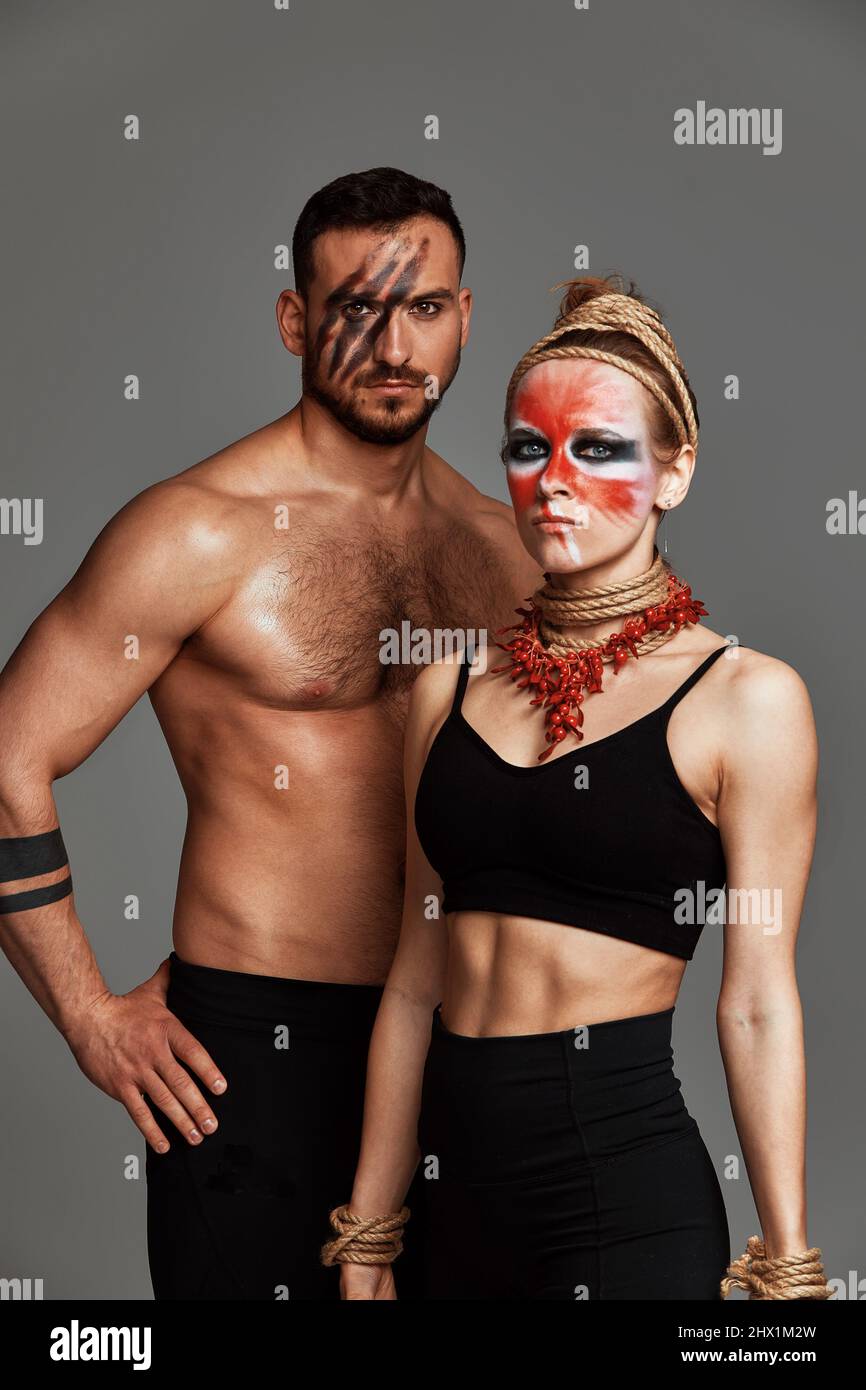 Beautiful young acrobats or gymnasts with colorful face painting on ...