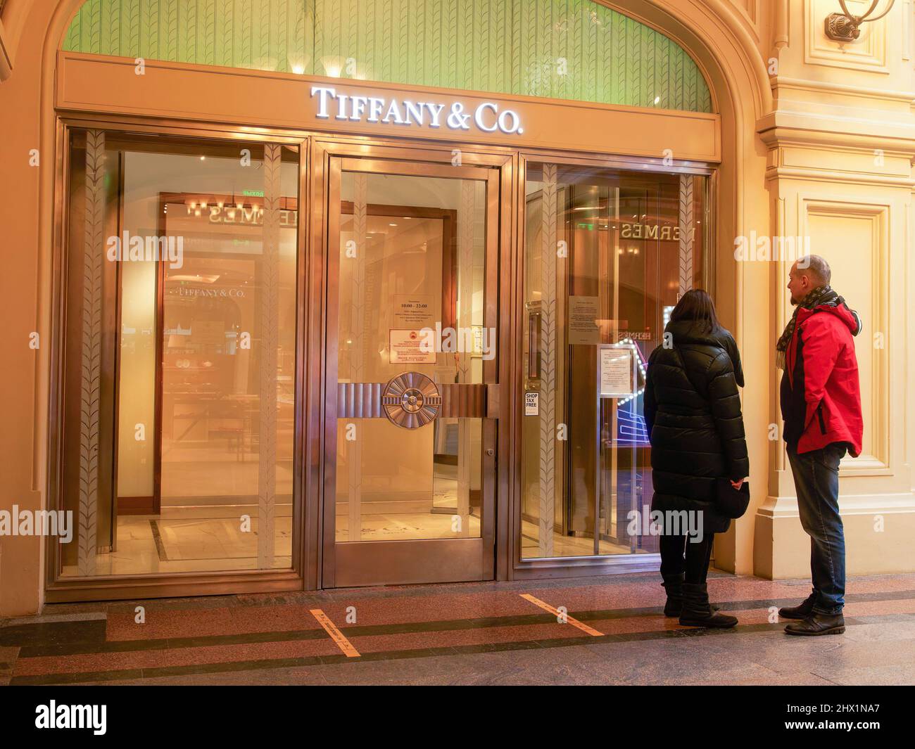 Moscow, Russia. 08th Mar, 2022. Shoppers stand in front of a closed