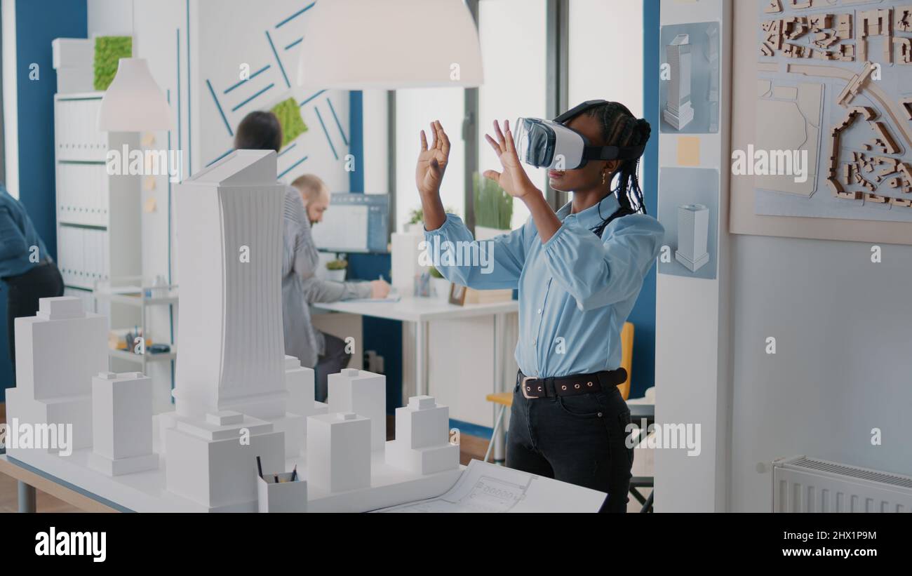 Architect using vr glasses to design building model and construction ...