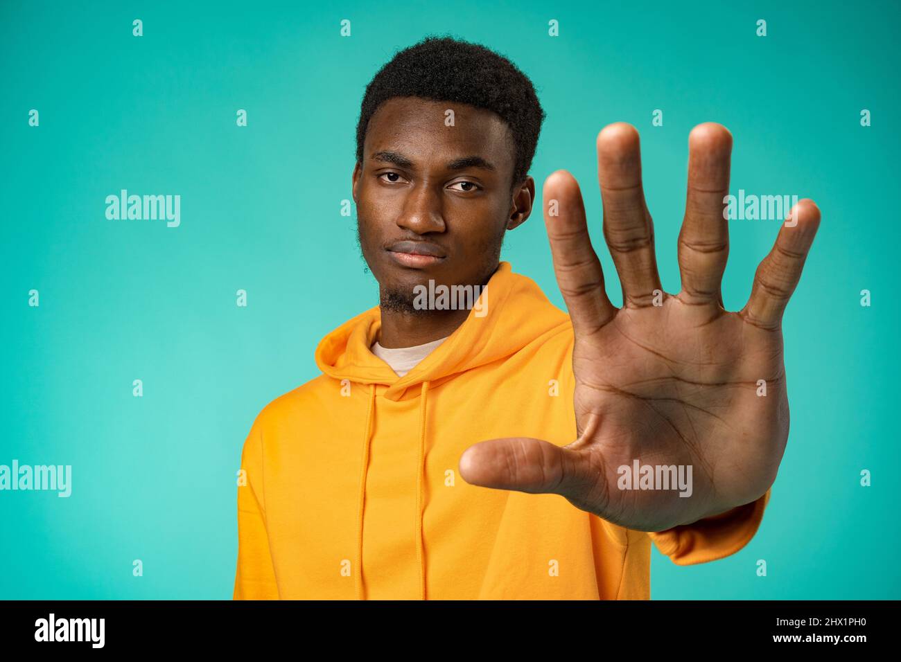 Young african american man over studio background doing stop sing with palm of the hand Stock Photo