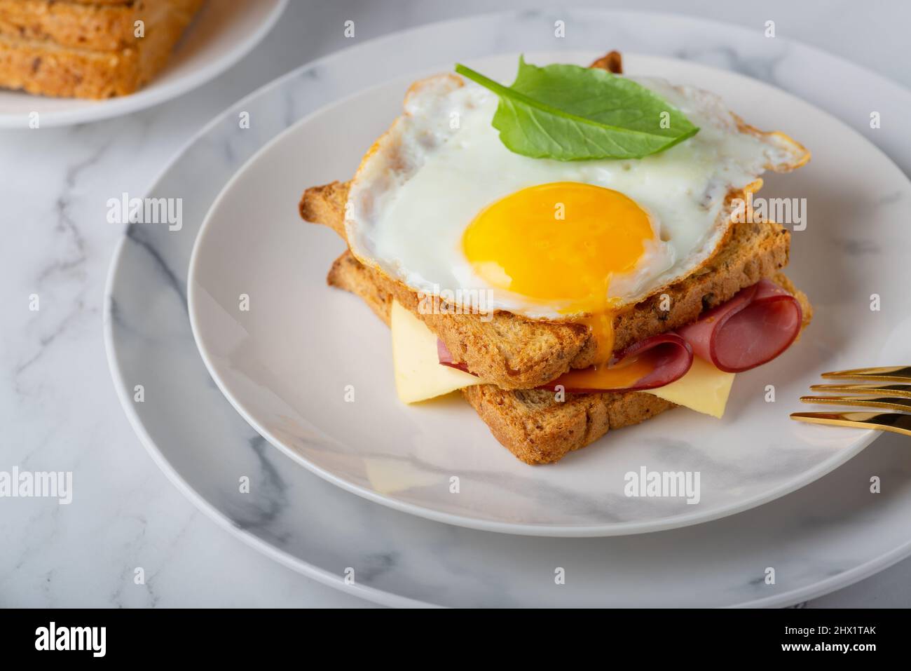 Sandwich with a fried egg, bacon, cheese and spinach Stock Photo Alamy