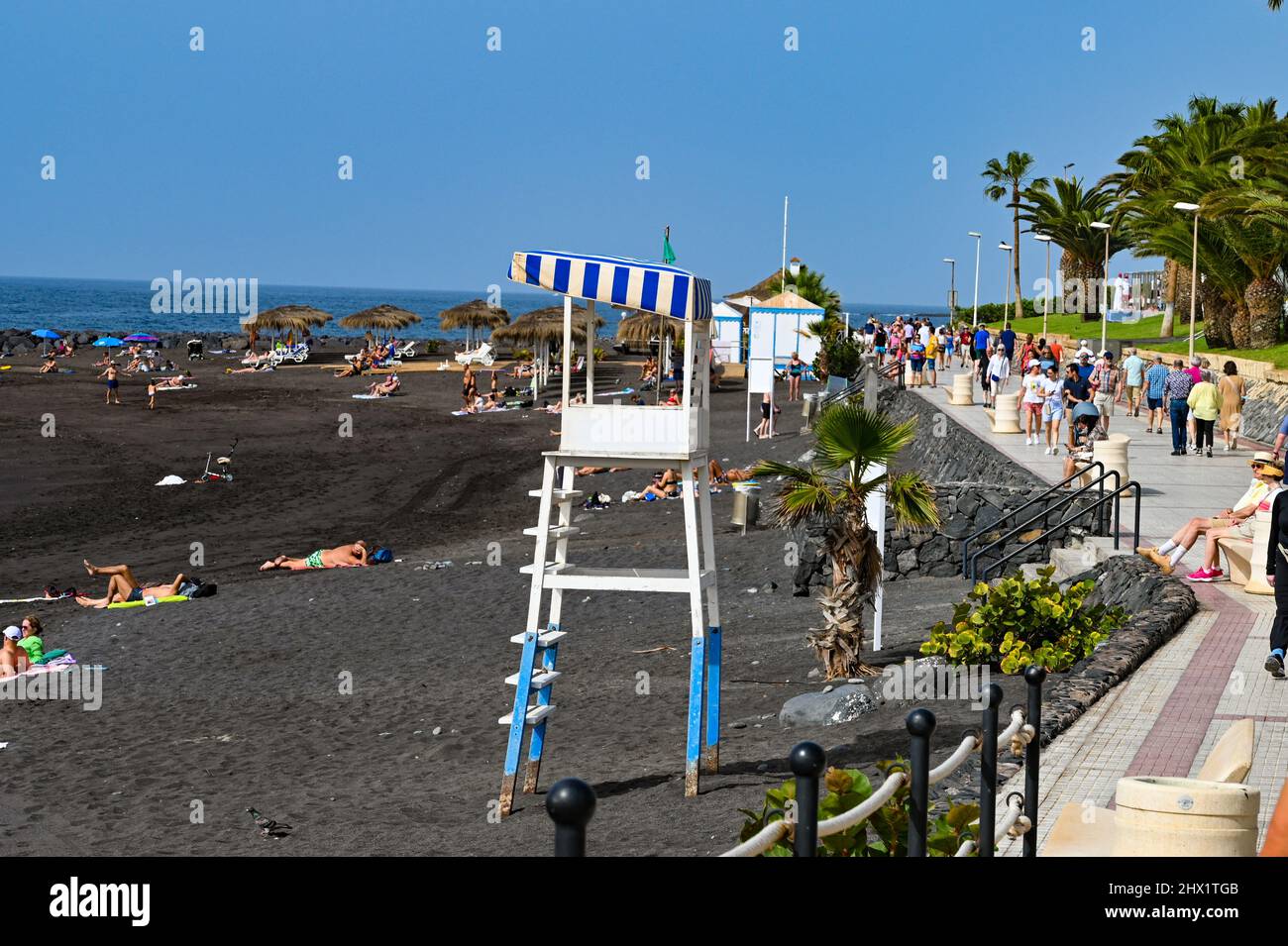 An empty lifeguard tower on a beach on the southern coast of Tenerife, in Costa Adeje, a beach made of volcanic rock as sand Stock Photo