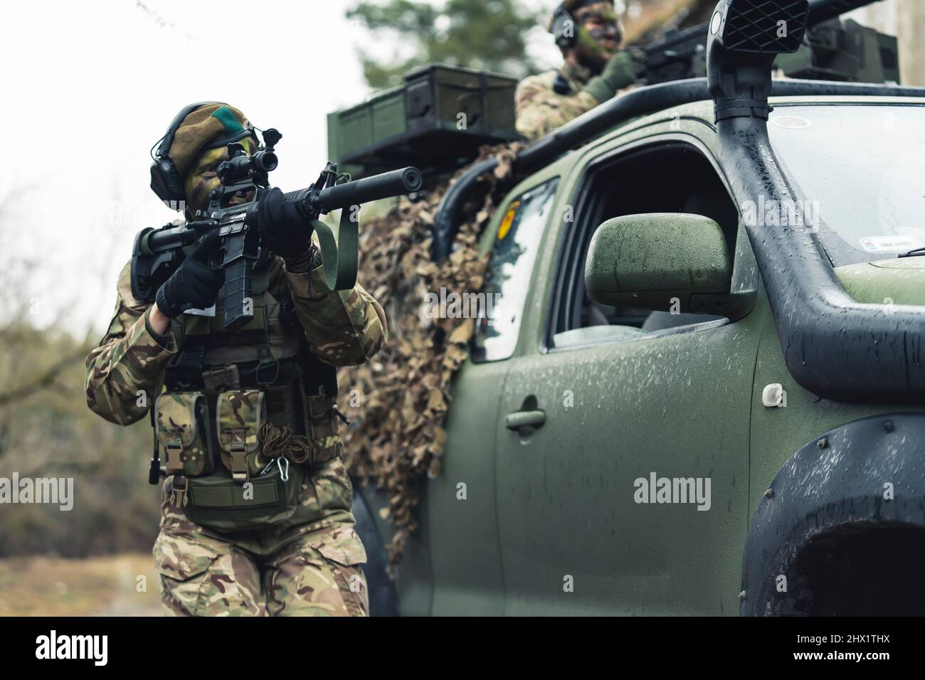 Female soldier confronting suspects on battlefield . High quality photo Stock Photo