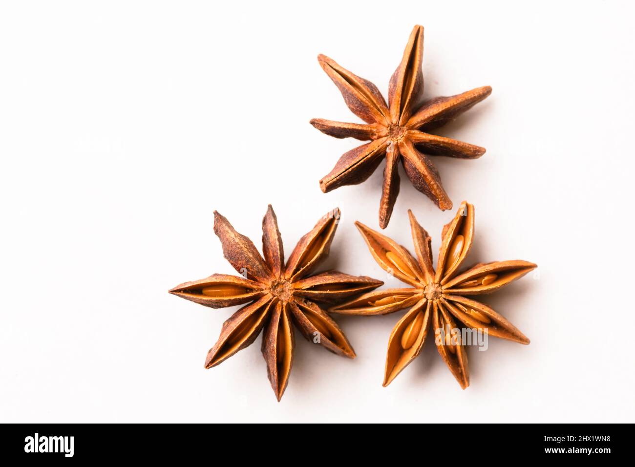 Three star anise whole spices pods on white colored background with