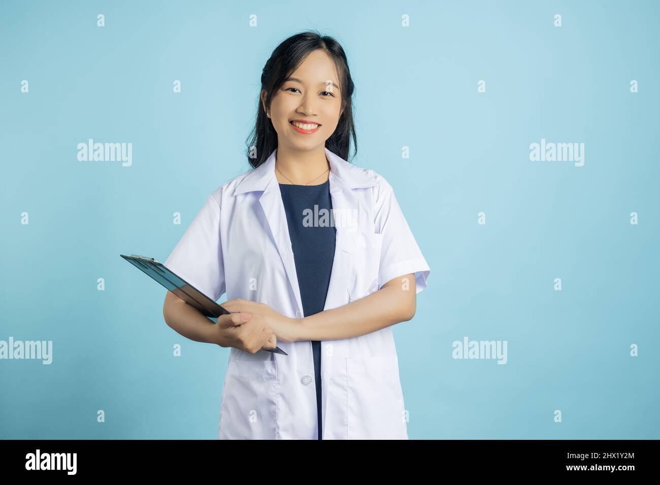 Portrait of young Asian beautiful nurse in white uniform with big ...