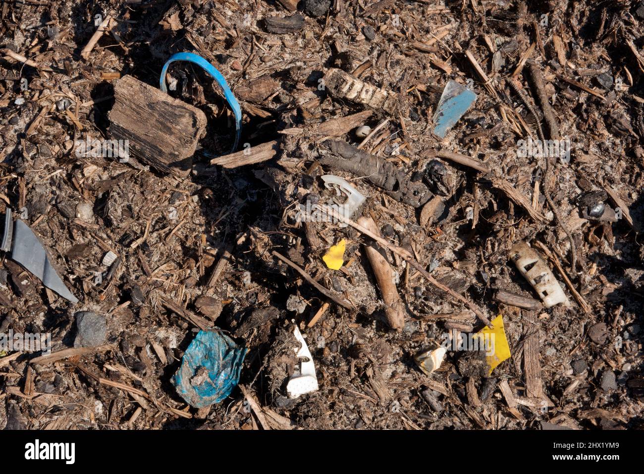 Plastic soup, detail of compost used in agriculture, polluted with plastic Stock Photo
