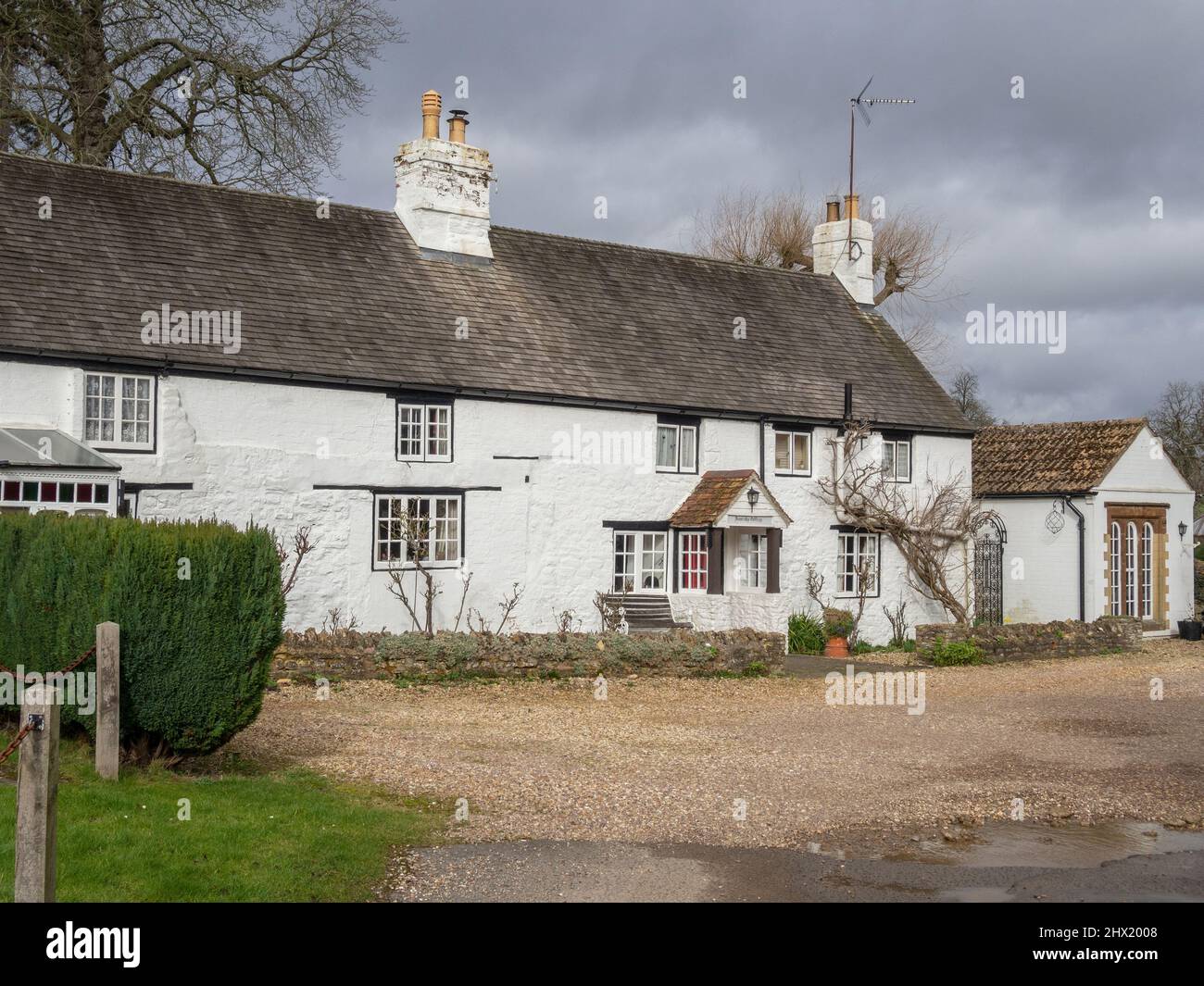 Attractive whitewashed stone cottage in the canal village of Stoke Bruerne, Northamptonshire, UK Stock Photo
