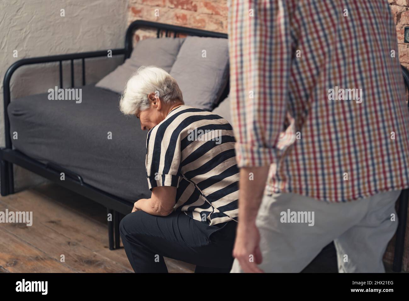 caucasian elderly pensioner lady collapses after a quarrel with her middle-aged son. High quality photo Stock Photo