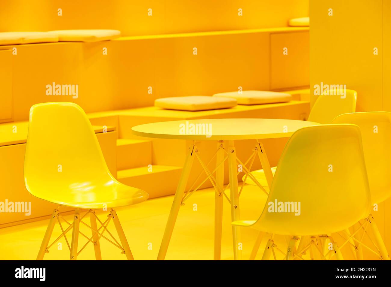 Yellow chairs and table indoor set. Contemporary comfortable plastic