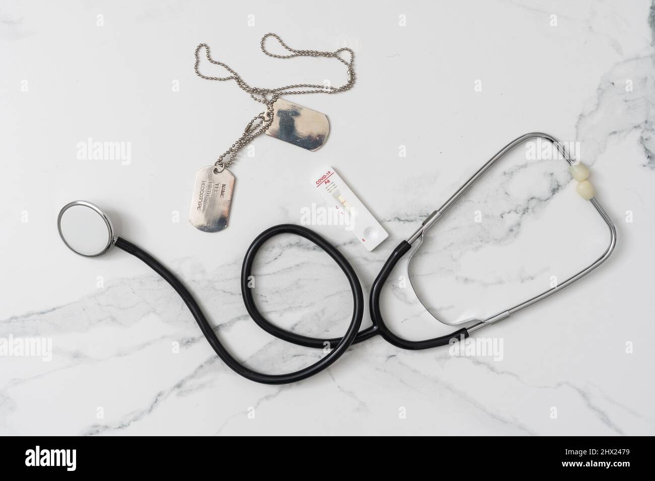 Military Health Care Concept. dog tags, stethoscope, and covid test