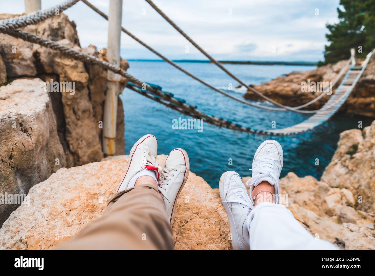 Man sitting on bridge legs hi-res stock photography and images - Alamy